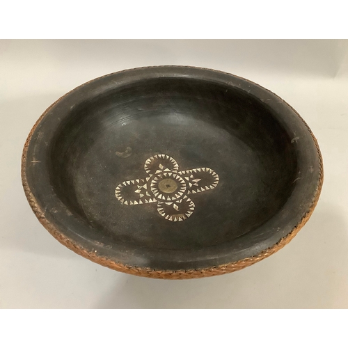 38 - An ebonised turned bowl with applied woven straw rim, inlaid in mother-of-pearl and Chinese coin to ... 