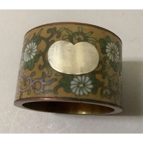 50 - A Japanese bronze napkin ring incised and applied in yellow metal with frog and egret amongst willow... 