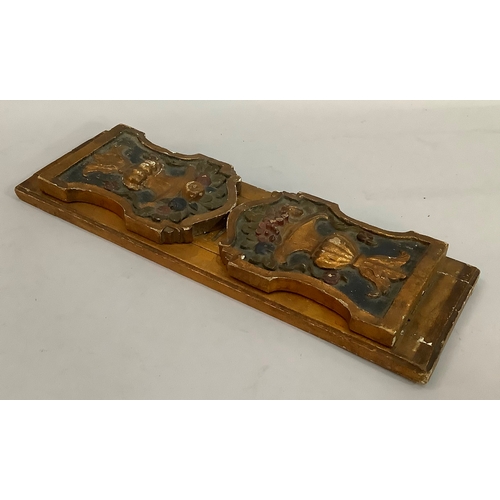 201 - A gilt and polychrome gesso folding book stand, the end panels carved in relief with flower-filled u... 