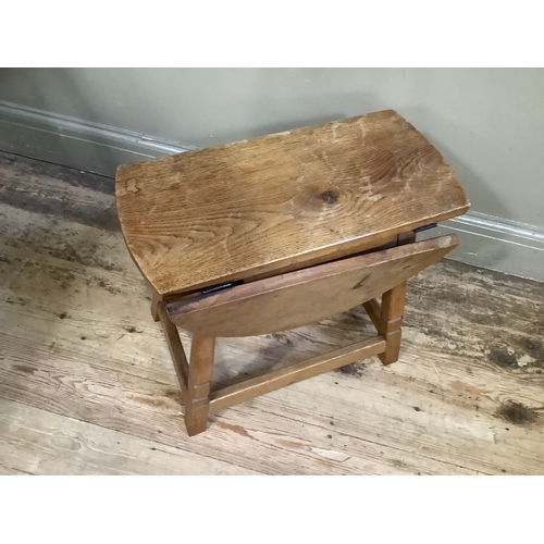 105 - An oak adzed drop-leaf side table with square legs and stretcher