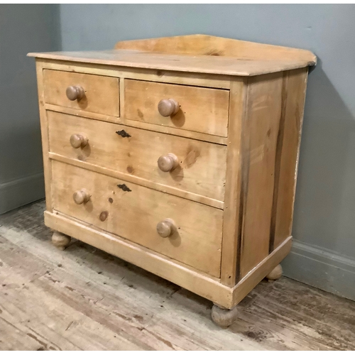 113 - A 19th century stripped pine chest of two short above two long drawers, with brass escutcheons, on b... 