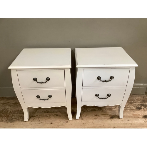 121 - A pair of modern cream bedside cabinets with two drawers, having bronzed handles, 50cm wide