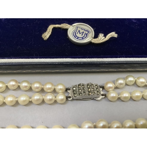 318 - A cultured pearl necklace approx 5.5mm size strung in two rows fastened with a silver marcasite set ... 