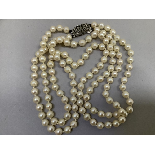 318 - A cultured pearl necklace approx 5.5mm size strung in two rows fastened with a silver marcasite set ... 