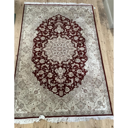 237 - A Turkish wool on cotton hand woven Durude rug, the wine field having an ivory rosette medallion and... 