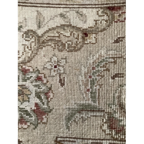 237 - A Turkish wool on cotton hand woven Durude rug, the wine field having an ivory rosette medallion and... 