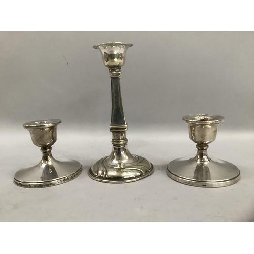 300 - A pair of silver short candlesticks, weighted bases, together with a silver plated candlestick with ... 