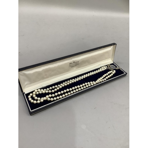 318 - A cultured pearl necklace approx 5.5mm size strung in two rows fastened with a silver marcasite set ... 