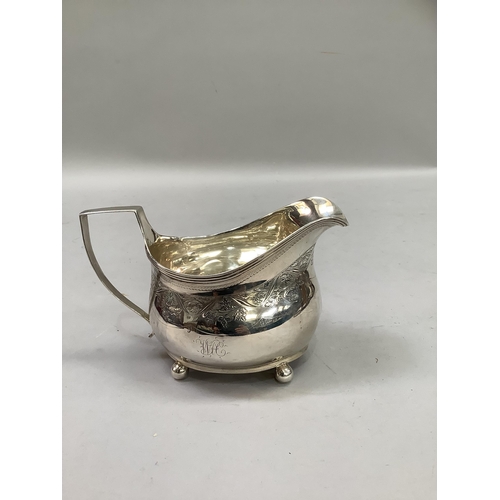 320 - A George III silver cream jug, London 1811 (maker not registered), foliate engraved and monogrammed,... 