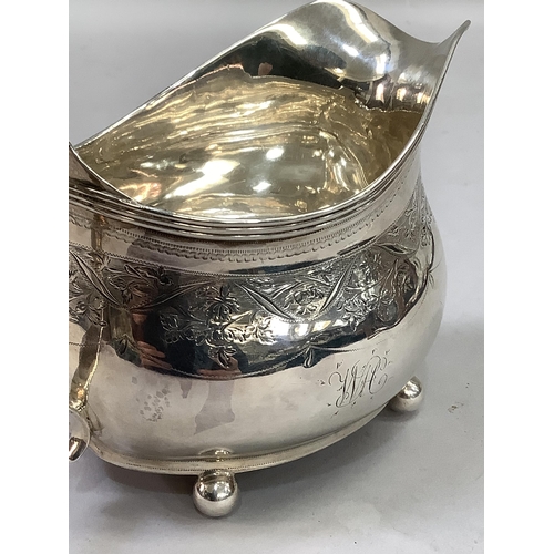 320 - A George III silver cream jug, London 1811 (maker not registered), foliate engraved and monogrammed,... 