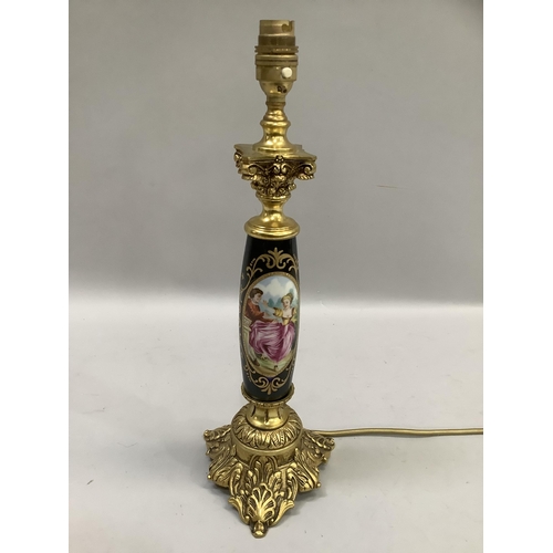 77 - A gilt and ceramic table lamp, the main column having a romantic scene below a Corinthian top, 40cm ... 