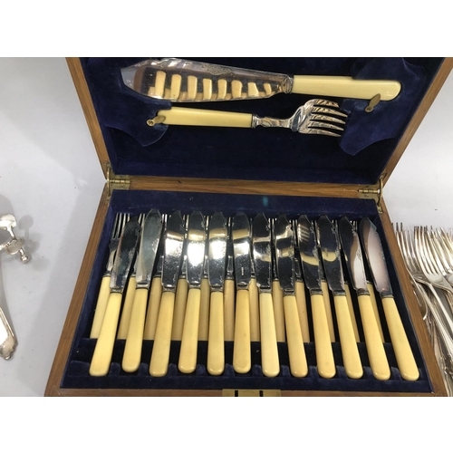 387 - An oak canteen of silver plated fish knives and forks with fish servers together with a further suit... 