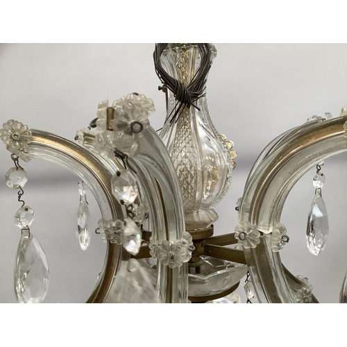 442 - An eighteen branch chandelier with glass drops and reeded arms