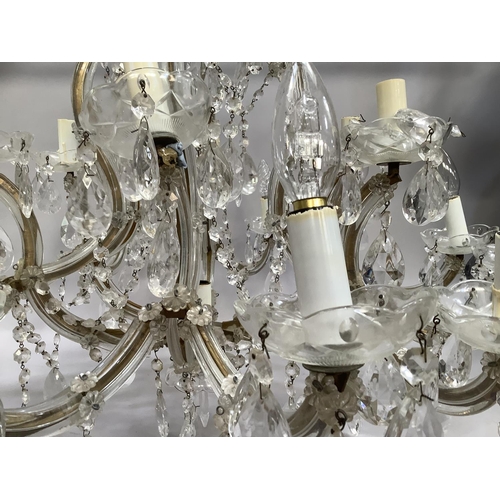 442 - An eighteen branch chandelier with glass drops and reeded arms