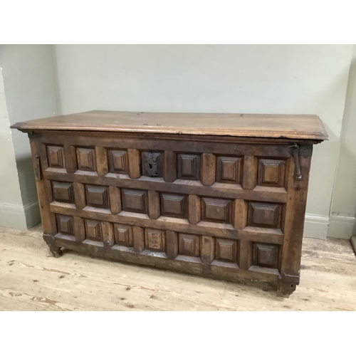 454 - A large continental fruitwood coffer with square panelling, iron bound on square legs