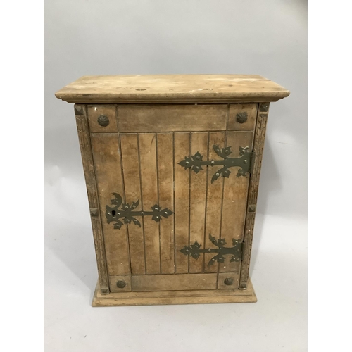 435 - A 19th century pine wall cabinet having a single door having strap handle and single escutcheon, the... 