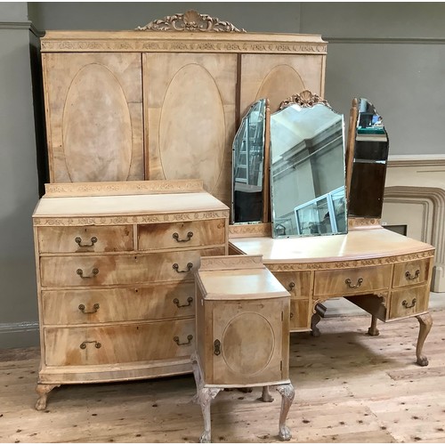 111 - A stripped mahogany bedroom suite comprising three panel wardrobe with C-scroll pediment, carved fri... 