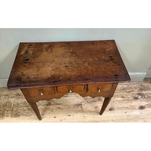 446 - An 18th century oak side table having three small drawers to the arched and shaped apron, on rounded... 