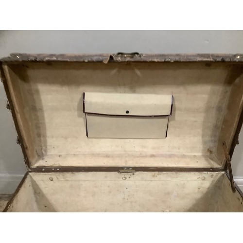 447 - A 19th century canvas and leather studded trim, brass mounted trunk having a slight domed top and le... 