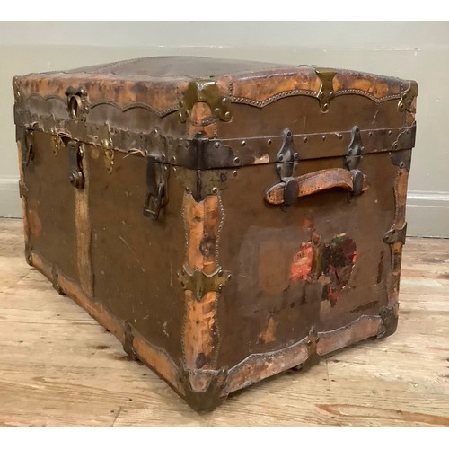 447 - A 19th century canvas and leather studded trim, brass mounted trunk having a slight domed top and le... 