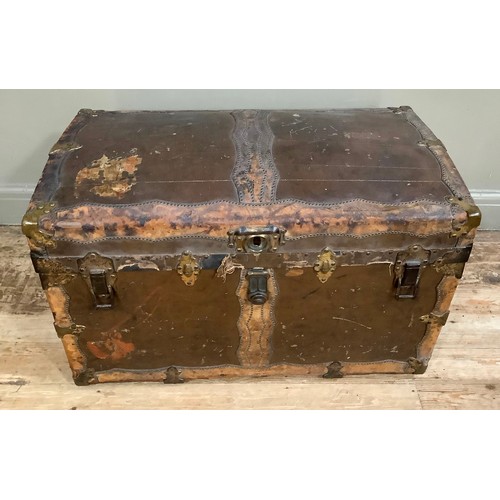 447 - A 19th century canvas and leather studded trim, brass mounted trunk having a slight domed top and le... 