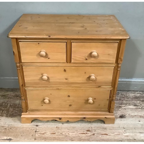 404 - A pine chest of two short and two long graduated drawers, turned handles and half turned pilasters t... 