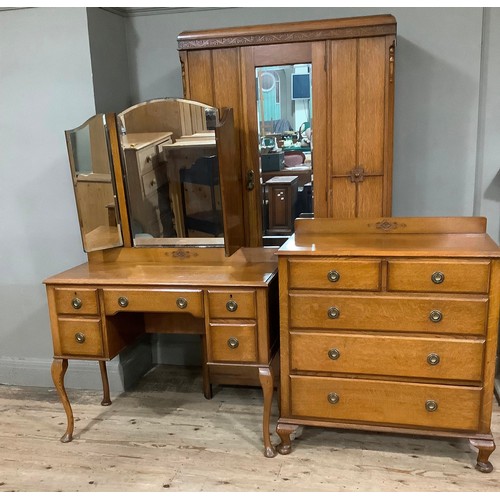 405 - An oak chest of two short and three long graduated drawers with ring handles and short cabriole legs... 