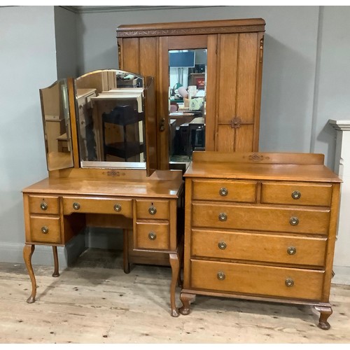 405 - An oak chest of two short and three long graduated drawers with ring handles and short cabriole legs... 