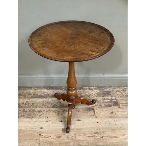 407 - A mahogany tripod table having a dished circular top on vase column and scrolled tripod base