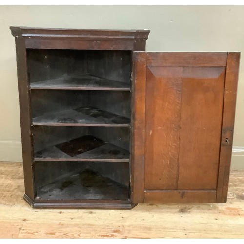 457 - A 19th century oak corner hanging cupboard having a moulded cornice over a single door, H brass hing... 