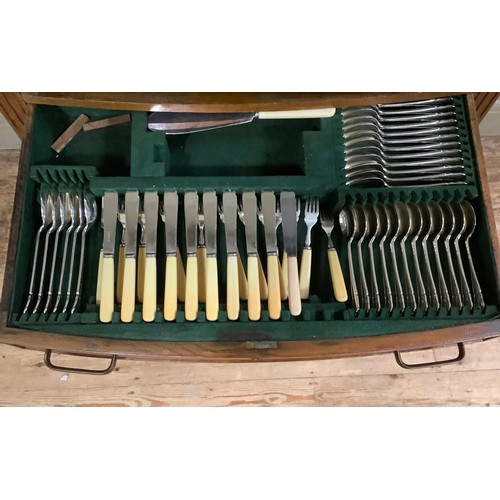 452 - An oak veneered two drawer table canteen containing a suite of silver plated cutlery for twelve comp... 