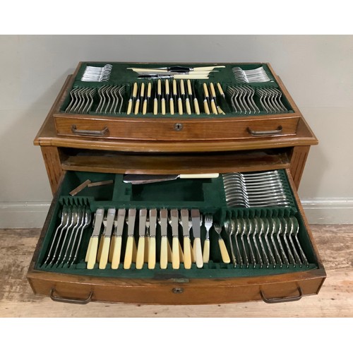 452 - An oak veneered two drawer table canteen containing a suite of silver plated cutlery for twelve comp... 