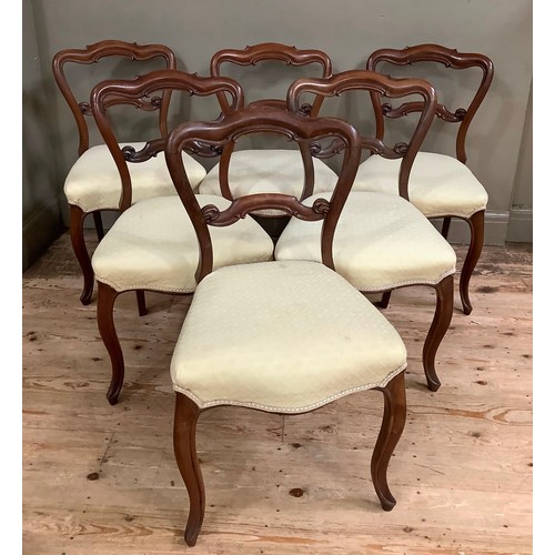 451 - A set of six Victorian walnut dining chairs having open moulded backs with tie rail, upholstered sea... 