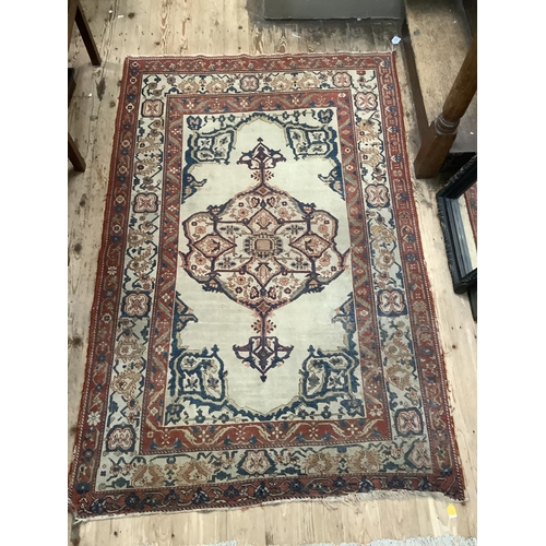 279 - A Persian kilim rug have a blue lozenge medallion on a cream field with a double red border, 184cm x... 