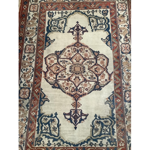 279 - A Persian kilim rug have a blue lozenge medallion on a cream field with a double red border, 184cm x... 