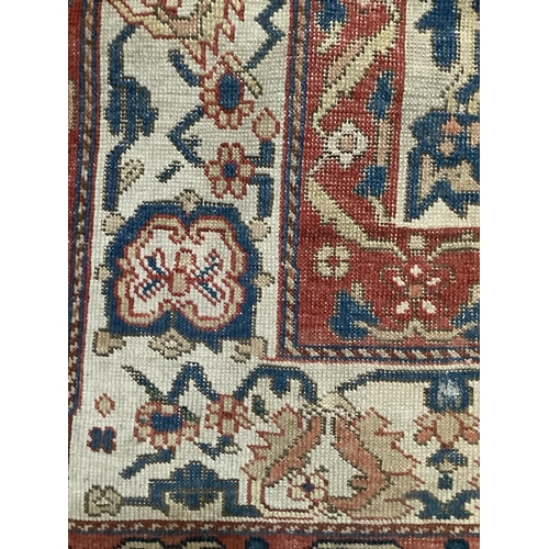 279 - A Persian kilim rug have a blue lozenge medallion on a cream field with a double red border, 184cm x... 