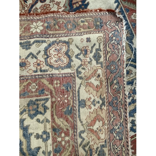 279 - A Persian kilim rug have a blue lozenge medallion on a cream field with a double red border, 184cm x... 