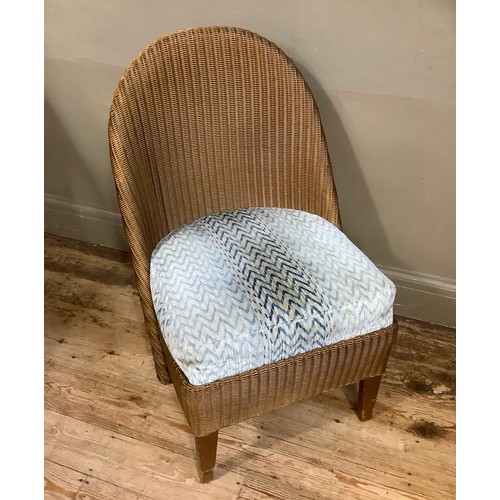 104 - A Lloyd Loom wicker chair, the canework in gilt with upholstered seat, having scalloped back