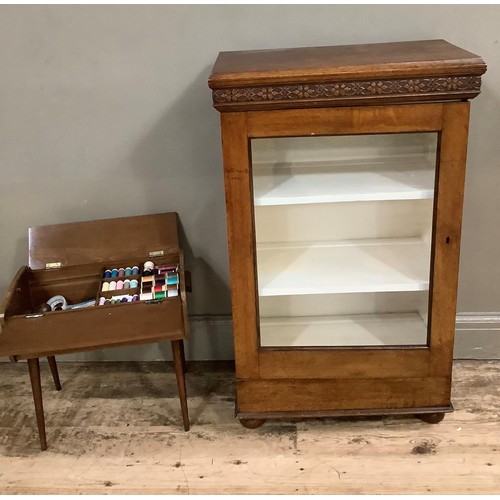 414 - An oak and glazed side cabinet together with a sewing box on legs