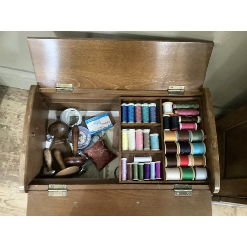 414 - An oak and glazed side cabinet together with a sewing box on legs