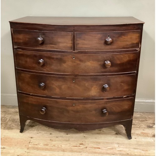 419 - An early 19th century mahogany bow fronted chest of two short over three long graduated drawers with... 