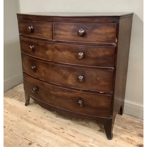 419 - An early 19th century mahogany bow fronted chest of two short over three long graduated drawers with... 