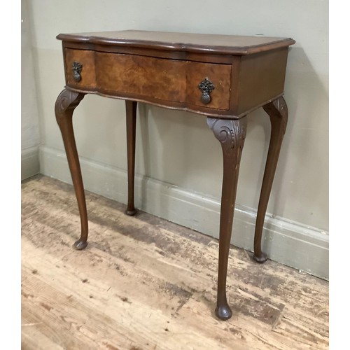 426 - A figured walnut side table of serpentine outline with drawer to frieze and on cabriole legs, 61cm w... 