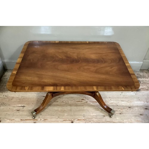 427 - A quality mahogany coffee table cross banded and on four lobed columns with platform and four reeded... 