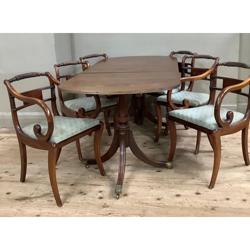 429 - A mahogany extending twin pedestal dining table together with a set of six Regency style dining chai... 