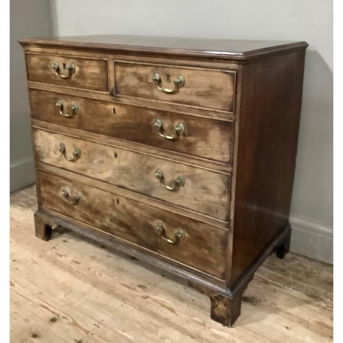 437 - A 19th century mahogany chest of two short and three long graduated drawers with brass swing handles... 