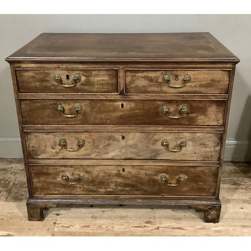 437 - A 19th century mahogany chest of two short and three long graduated drawers with brass swing handles... 