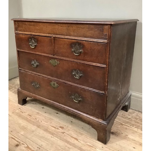 438 - An 18th century oak chest having a deep frieze over two short and two long graduated drawers, on sha... 