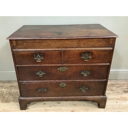 438 - An 18th century oak chest having a deep frieze over two short and two long graduated drawers, on sha... 