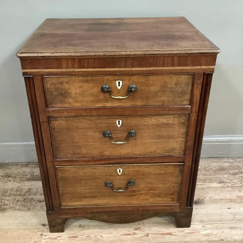 439 - An oak and mahogany chest of three graduated drawers with bone escutcheons flanked by reeded pilaste... 